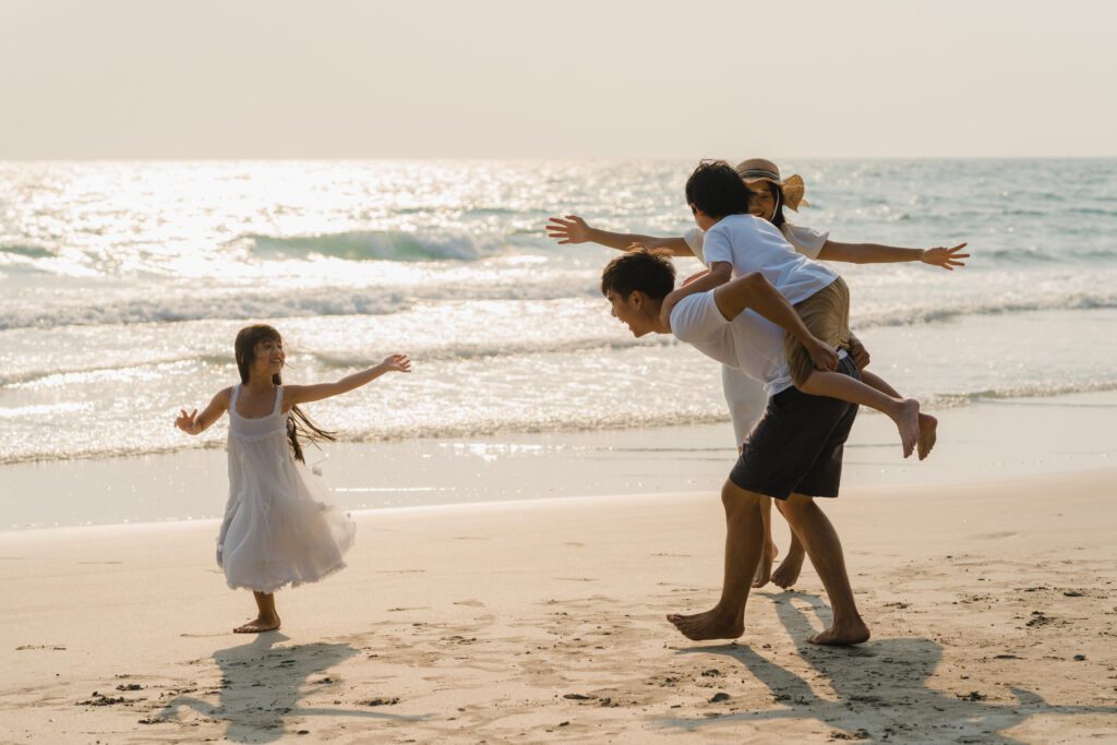 asian young happy family enjoy vacation beach evening dad mom kid relax playing together near sea when sunset while travel holiday lifestyle travel holiday vacation summer concept